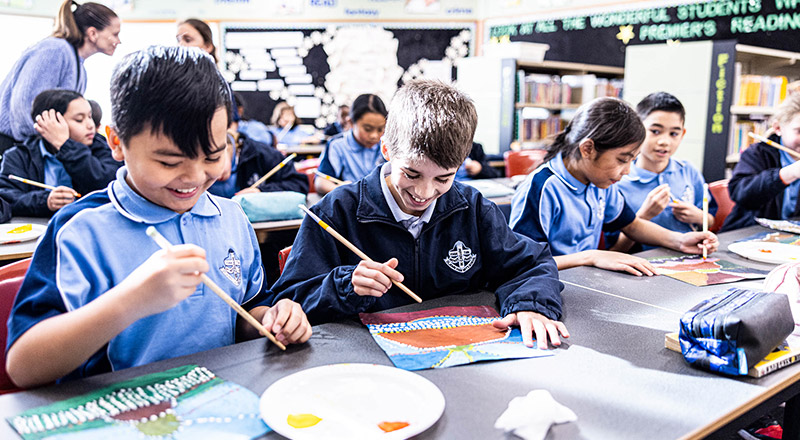 Students painting in class at St John Vianney's Catholic Primary Doonside