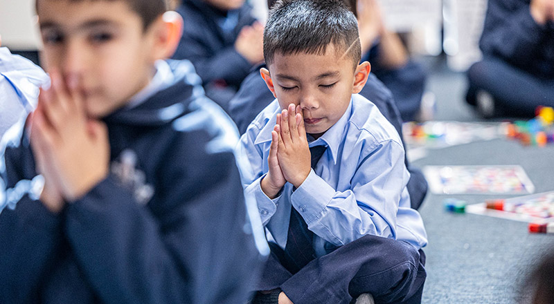 Students praying at St John Vianney's Catholic Primary Doonside