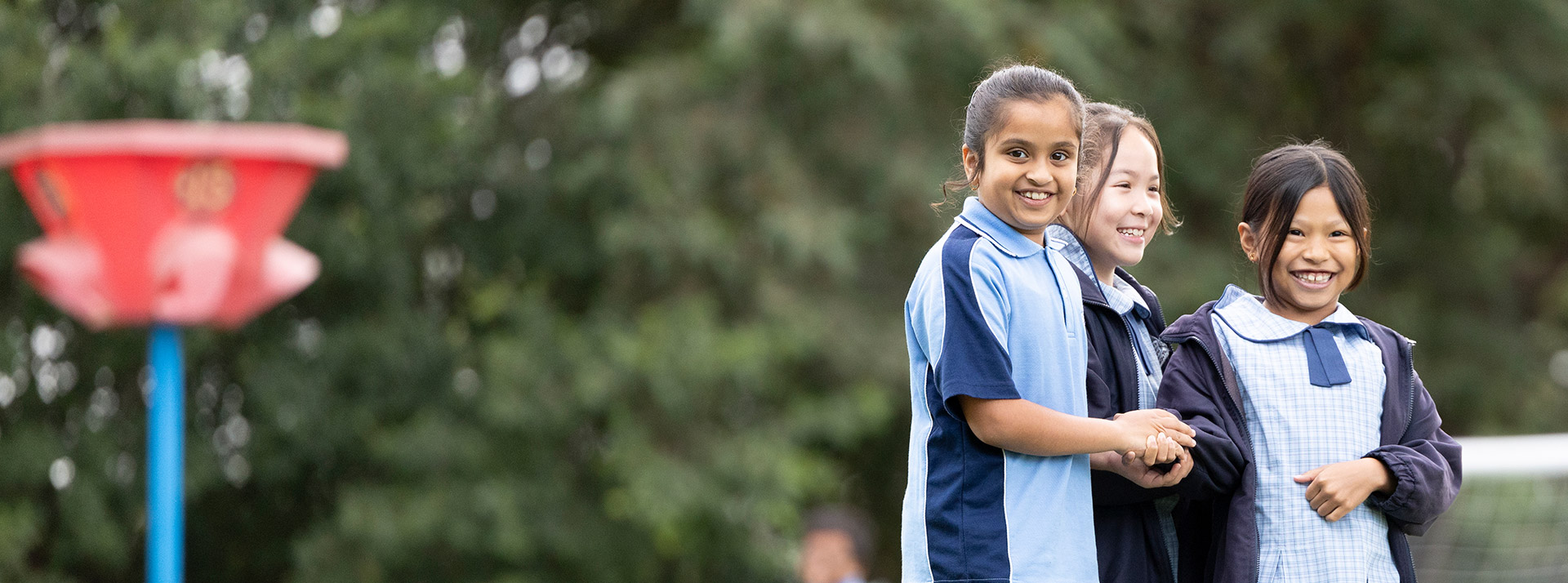 Three St John Vianney's Doonside girls in the playground outside