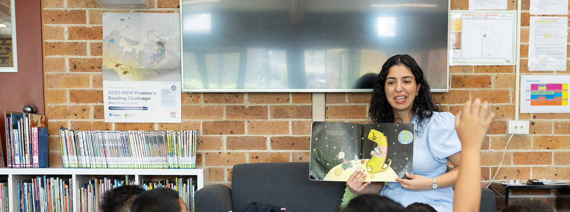Dedicated Teachers at St John Vianney's Catholic Primary Doonside. Teacher is reading to class.