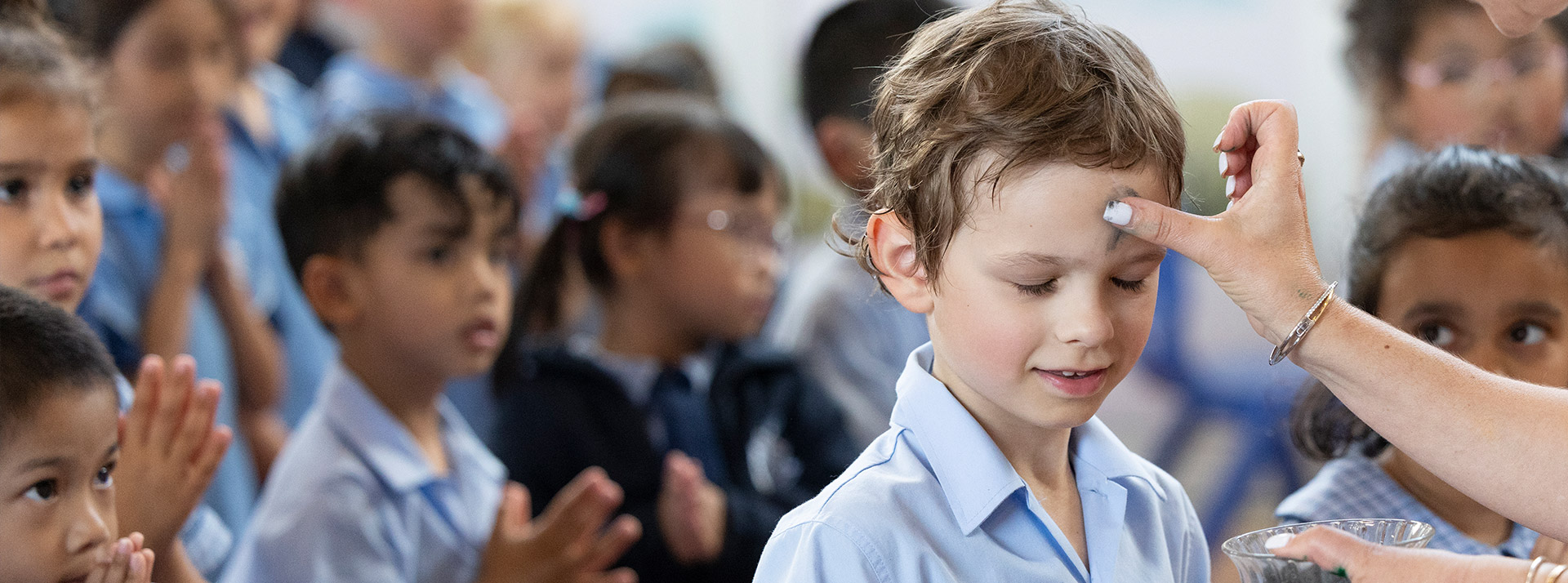 Student in prayer during class at St John Vianney's Primary School Doonside