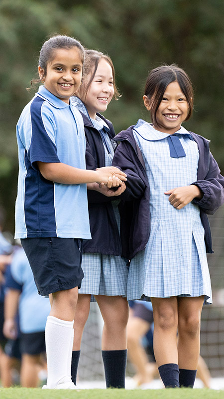 Three St John Vianney's Doonside girls in the playground outside