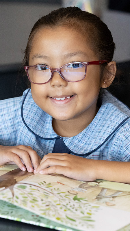 St John Vianney's Primary Doonside Girl reading from book