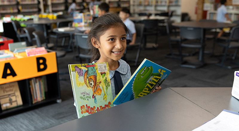 St John Vianney's Doonside student checking out book