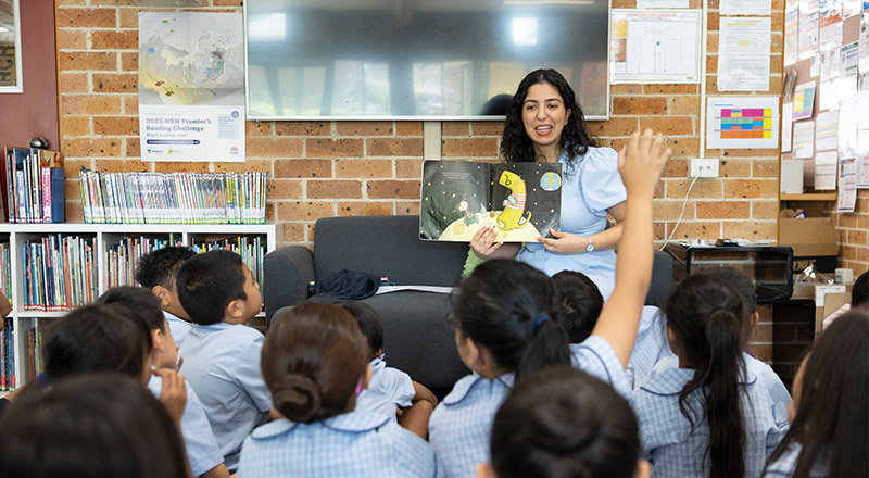 Dedicated Teachers at St John Vianney's Catholic Primary Doonside. Teacher is reading to class.