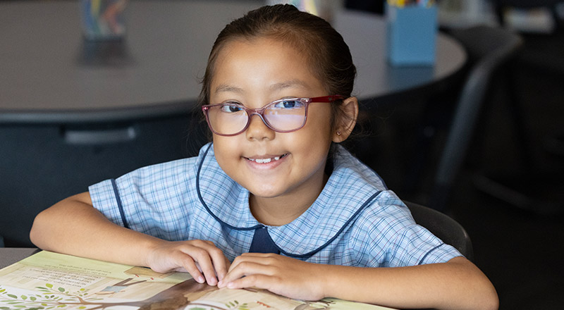 St John Vianney's Primary Doonside Girl reading from book