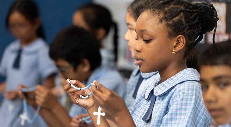 St John Vianney's Doonside student praying with Rosary Beads